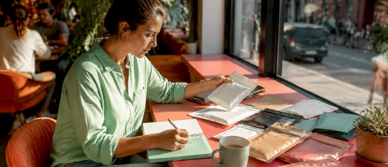 Person reviewing packaging samples at office table