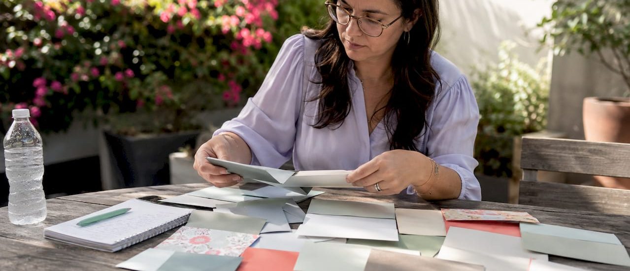 Professional examining mail envelope samples at desk