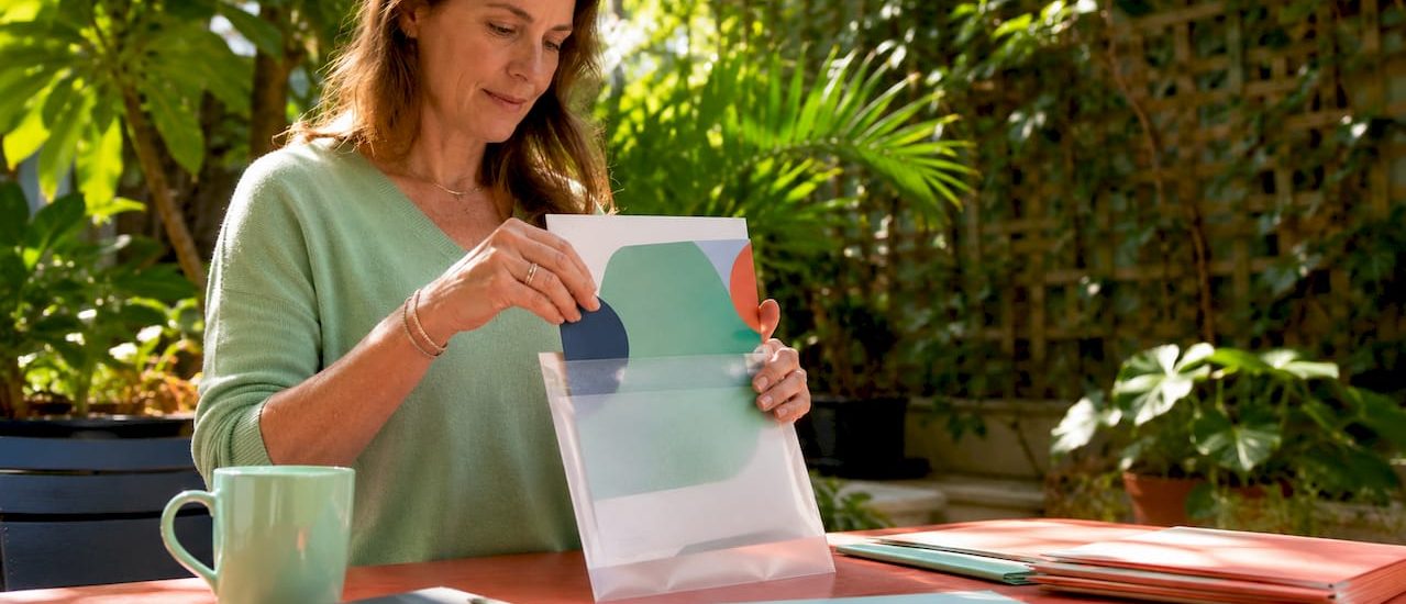 Marketer placing brochure in mail insert envelope